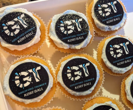 Iced cupcakes with edible printed toppers that are branded with the Guildford Thunder Korfball Club logo 